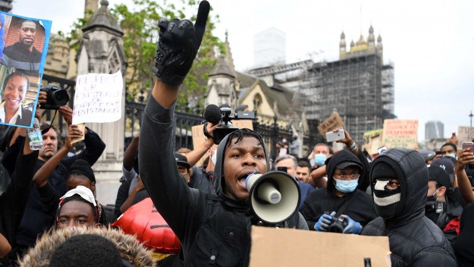 British actor John Boyega speaks to protestors in Parliament square during an anti-racism demonstration in London, on June 3, 2020, after George Floyd, an unarmed black man died after a police officer knelt on his neck during an arrest in Minneapolis, USA. - Londoners defied coronavirus restrictions and rallied on Wednesday in solidarity with protests raging across the United States over the death of George Floyd, an unarmed black man who died during an arrest on May 25.