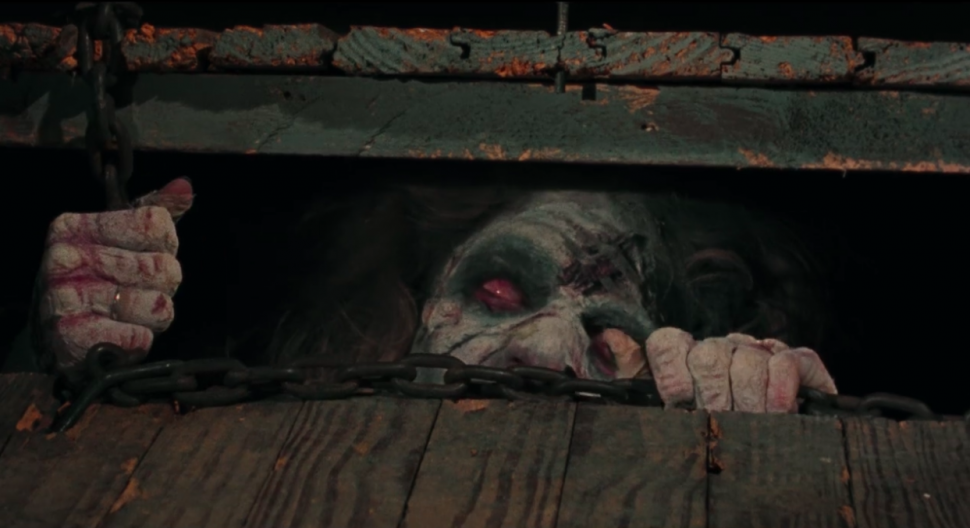 An undead demon peaks out from the basement in 'The Evil Dead.'