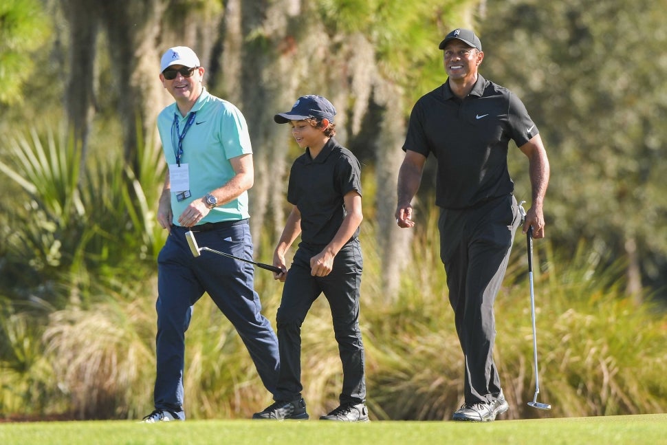 Tiger Woods and his son Charlie Woods practice together during the PGA TOUR Champions Friday Pro-am at PNC Championship at Ritz-Carlton Golf Club on December 17, 2021 in Orlando, Florida. 