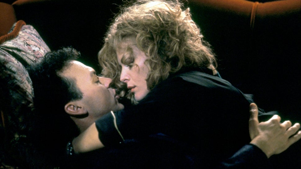 Michael Keaton and Michelle Pfeiffer sharing an intimate moment in 'Batman Returns.'