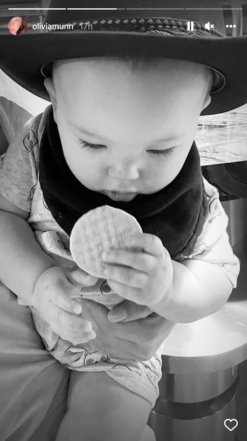 John Mulaney and Olivia Munn's son Malcolm eats a cracker on 9-month birthday