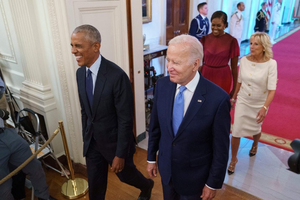Former US President Barack Obama and US President Joe Biden, followed by former US First Lady Michelle Obama and US First Lady Jill Biden