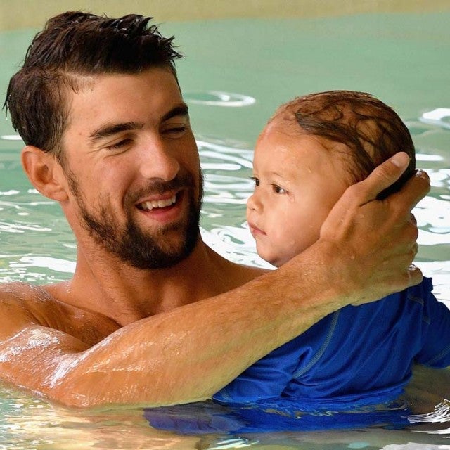Michael Phelps swims in a pool with son Boomer.