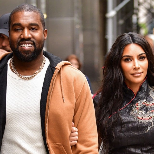 Kanye West and Kim Kardashian West walk along 57th Street