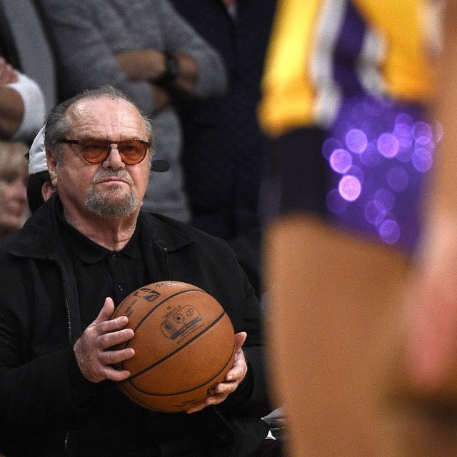Jack Nicholson holds the game ball as he attends a basketball game between the Golden State Warriors and Los Angeles Lakers before Laker legend Kobe Bryant's jersey was retired at Staples Center on December 18, 2017 in Los Angeles, California.