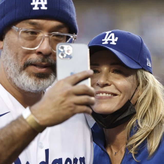 Comedian Jo Koy (L) and Comedian/actress Chelsea Handler (R) takes a selfie prior to a game between the Los Angeles Dodgers and the Atlanta Braves at Dodger Stadium on August 31, 2021 in Los Angeles, California