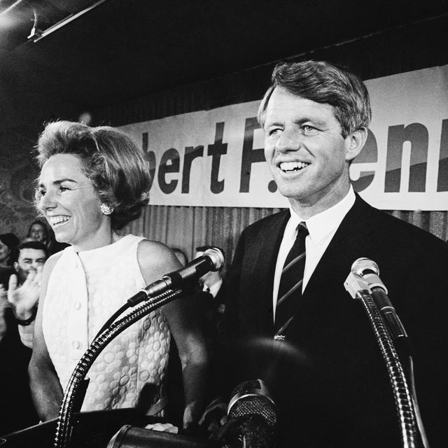 An exuberant Robert F. Kennedy addresses an enthusiastic throng at campaign headquarters after Indiana primary election victory. At left is Kennedy's wife Ethel.