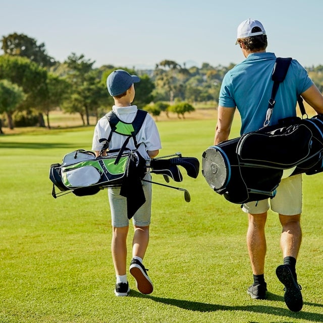man and son playing golf