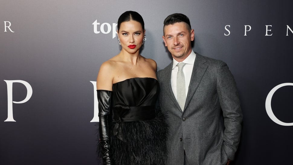 Adriana Lima and Andre Lemmers pose on the red carpet. 