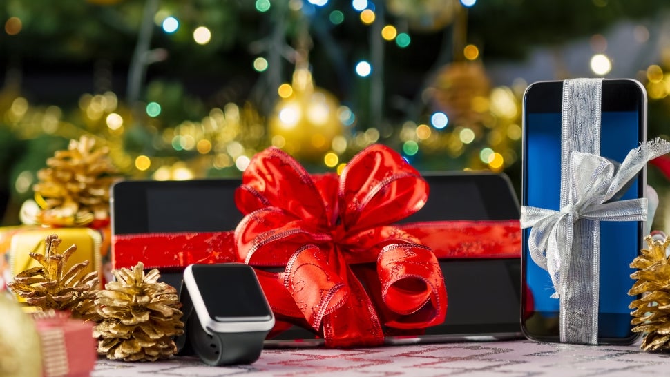 tablet and cellphone wrapped under christmas tree